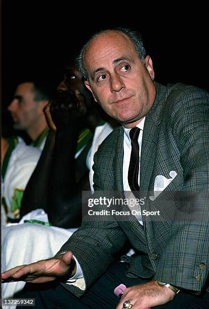 Head coach Red Auerbach of the Boston Celtic watches the action from the the bench during an NBA basketball game circa 1964 at the Boston Garden in...