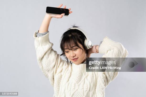 a beautiful asian girl wearing headphones and enjoying the music - jive dancing stock pictures, royalty-free photos & images