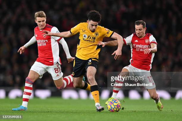 Rayan Ait-Nouri of Wolverhampton Wanderers is tackled by Martin Odegaard and Cedric Soares of Arsenal during the Premier League match between Arsenal...