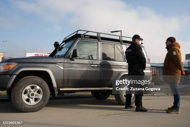 Reporter from the Slovak television station Joj speaks with the policeman on the Slovak side of International border crossing Vysne Nemecke on...