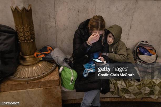 People shelter in a subway station before a curfew comes into effect on February 24, 2022 in Kyiv, Ukraine. Overnight, Russia began a large-scale...