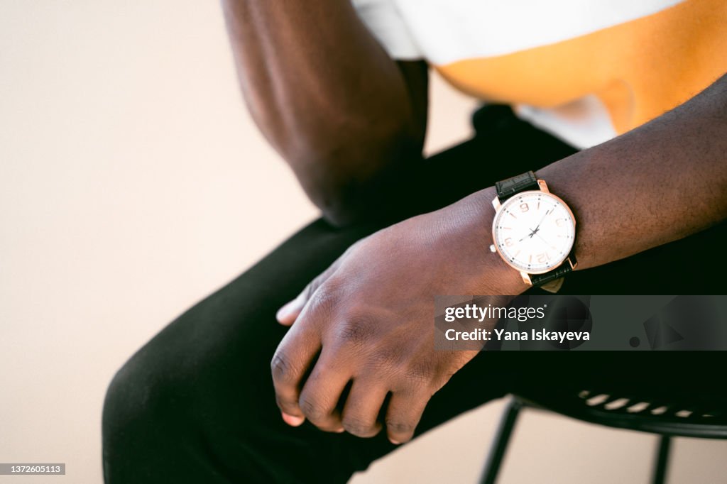 Dark skin hand with classical watch on the wrist
