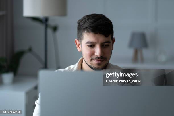 young man working at home - turk telekom bildbanksfoton och bilder