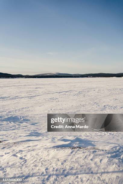 landscape image of snow covered lake inari in winter. - frozen lake stock pictures, royalty-free photos & images