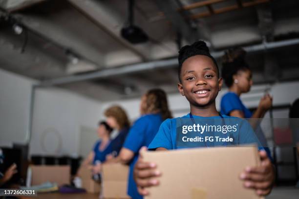 portrait of boy holding a charity box - sweet charity stock pictures, royalty-free photos & images