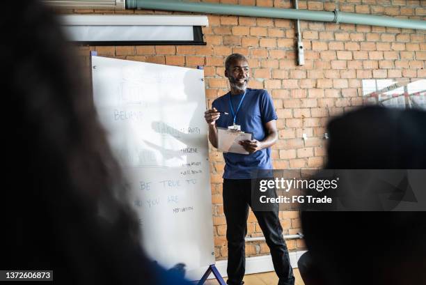 mature man talking in a meeting at a community center - community center bildbanksfoton och bilder