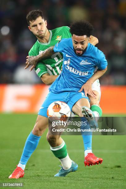 Guido Rodríguez of Real Betis in action with Claudinho of Zenit St. Petersburg during the UEFA Europa League Knockout Round Play-Offs Leg Two match...