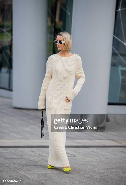 Nataly Osmann seen wearing silver Prada bag, neon heels, white sunglasses, beige knitted dress outside Max Mara fashion show during the Milan Fashion...