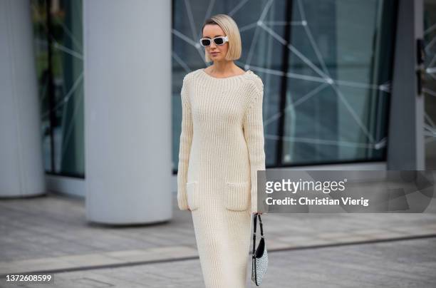 Nataly Osmann seen wearing silver Prada bag, neon heels, white sunglasses, beige knitted dress outside Max Mara fashion show during the Milan Fashion...