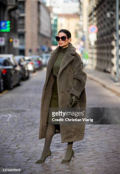 Victoria Barbara is seen wearing total look Max Mara: olive green coat, jumper, gloves, skirt, tights, heels outside Max Mara during the Milan...