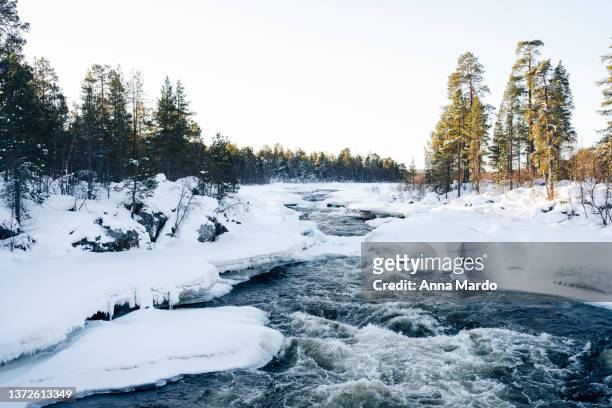 juutuanjoki river in winter with snow and ice - inari finland bildbanksfoton och bilder