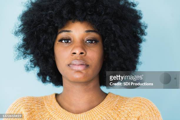 close up melancholy young adult woman - natural hair model stock pictures, royalty-free photos & images