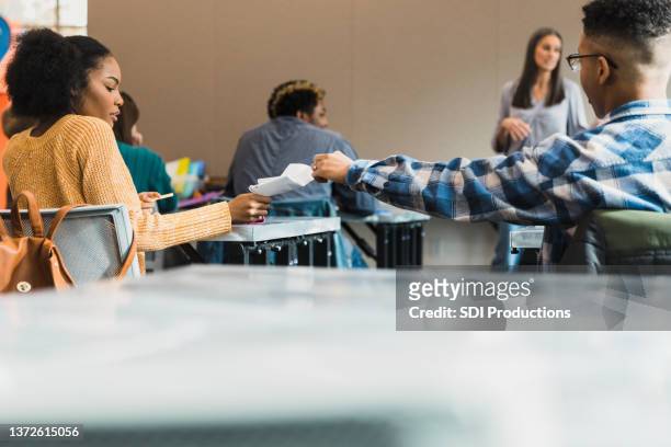 students pass note during class - student uprising stock pictures, royalty-free photos & images