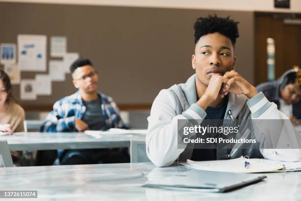 bored high school student day dreaming during class - bored student stock pictures, royalty-free photos & images