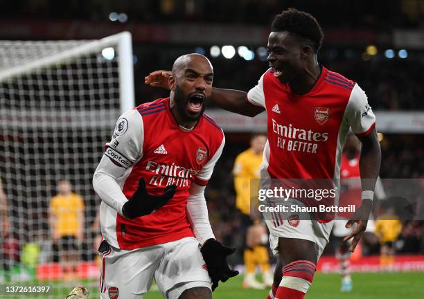 Alexandre Lacazette of Arsenal celebrates their sides second goal with team mate Bukayo Saka during the Premier League match between Arsenal and...