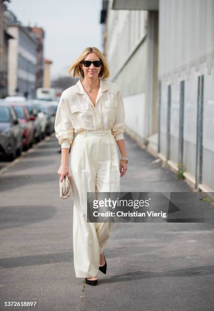 Lisa Aiken seen wearing creme white pants, button shirt, micro bag outside Sunnei fashion show during the Milan Fashion Week Fall/Winter 2022/2023 on...