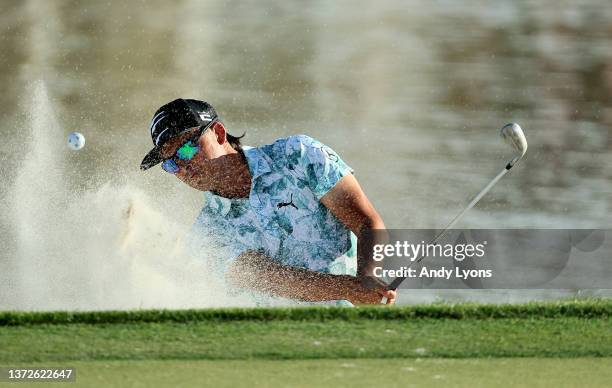 Rickie Fowler plays a shot from a bunker on the 17th hole during the first round of The Honda Classic at PGA National Resort And Spa on February 24,...