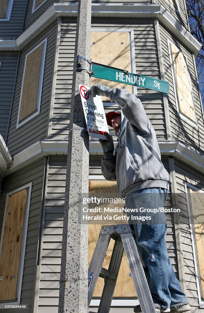 (021408 Boston, MA) A member of Graffiti Busters cleans a wall in front of a triple-decker on Hendry Street in Dorchester, Thursday, February 14, 2008. Staff photo by Angela Rowlings.