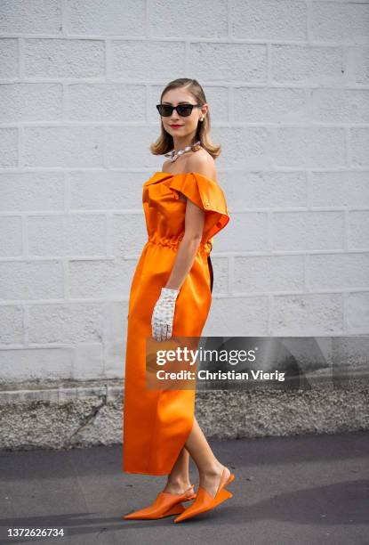 Jenny Walton seen wearing orange backless zipped dress, gloves with print outside Prada fashion show during the Milan Fashion Week Fall/Winter...