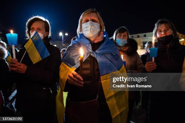 Demonstrators hold candles during a vigil as they gather to protest against the Russian military invasion of Ukraine on February 24, 2022 in Pompei,...