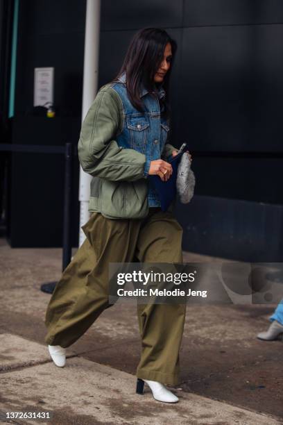 Roopal Patel - SVP, Fashion Director - Saks Fifth Avenue wears a blue denim and green quilted jacket, oversized green trousers, and white heels at...