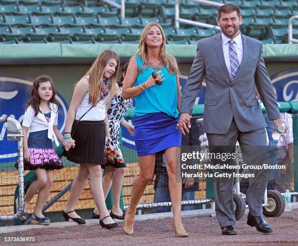 Boston Red Sox catcher Jason Varitek walks out of the dugout with his wife Catherine and daughters Ally 12, Kendall 10 and Caroline 6 during his...