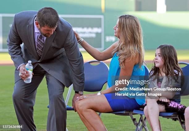 Boston Red Sox catcher Jason Varitek sits down next to his wife Catherine and daughters Caroline 6 after announcing his retirement announcement at...