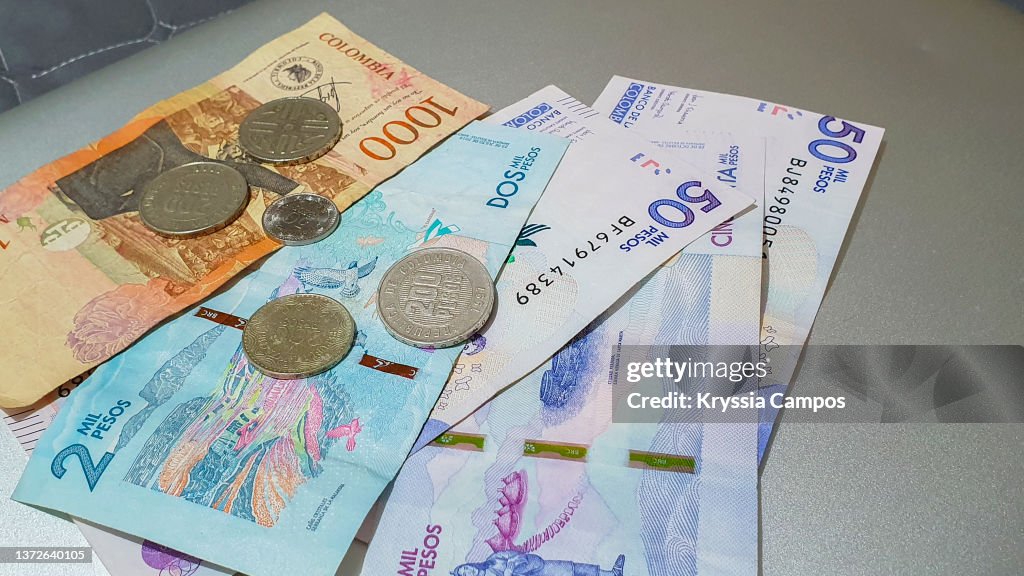 Pile of Colombian Pesos Bills and Coins