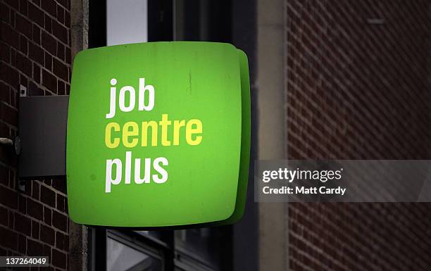 The Jobcentre Plus logo is seen displayed outside the employment office on January 18, 2012 in Trowbridge, England. Figures released today show that...