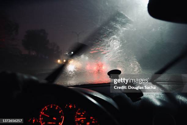 rainy night driving pov - car window stockfoto's en -beelden