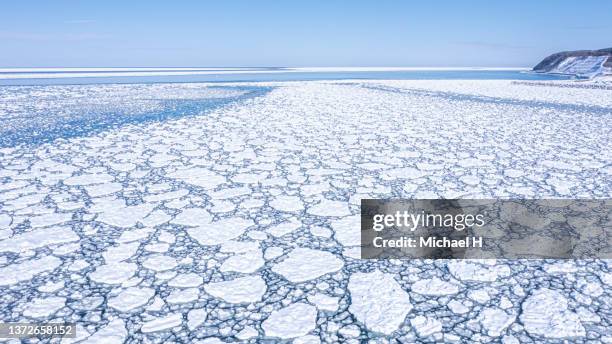 drift ice on the shiretoko peninsula. aerial view. - mar de okhotsk imagens e fotografias de stock