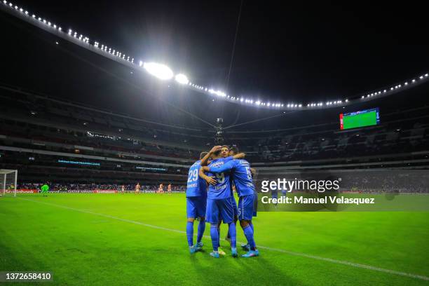 Angel Romero of Cruz Azul celebrates after scoring the first goal of his team with teammates during the round of 16 2nd leg match between Cruz Azul...