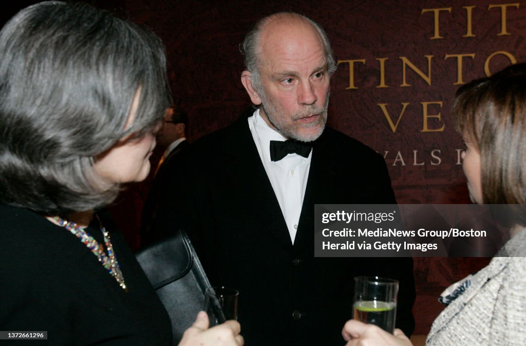 (030709 Boston, MA) Actor John Malkovich (C) and girlfriend Nicoletta Peyran (L) stop to chat with an acquaintance before heading in to the opening of Titian, Tintoretto, Veronese: Rivals in Renaissance Venice exhibit. Photo by Matthew Healey