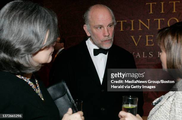 Actor John Malkovich and girlfriend Nicoletta Peyran stop to chat with an acquaintance before heading in to the opening of Titian, Tintoretto,...