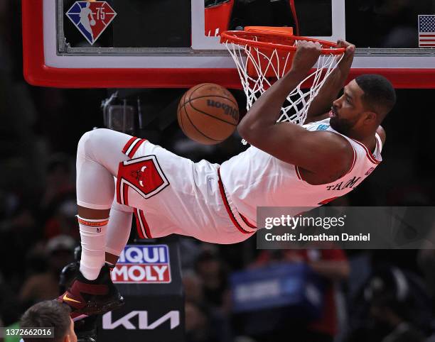 Tristan Thompson of the Chicago Bulls hangs on the rim after dunking against the Atlanta Hawks at the United Center on February 24, 2022 in Chicago,...