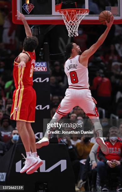 Zach LaVine of the Chicago Bulls puts up a shot past Danilo Gallinari of the Atlanta Hawks at the United Center on February 24, 2022 in Chicago,...