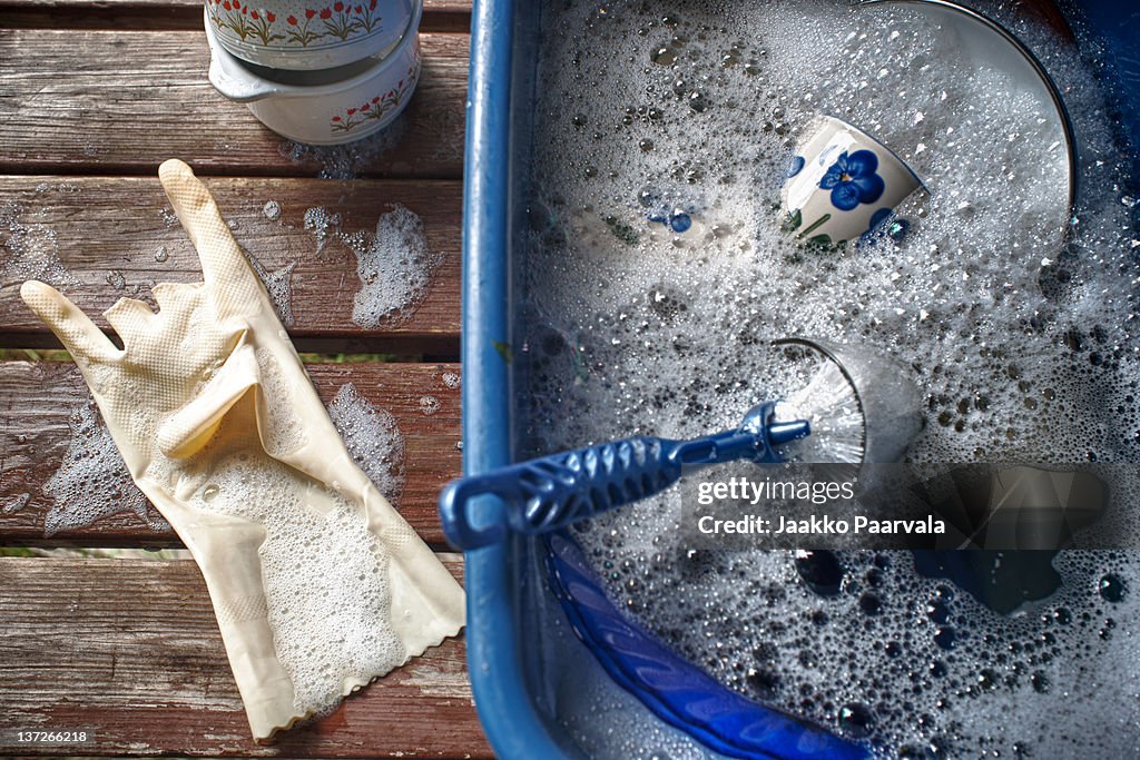 Washing dishes in soapy water