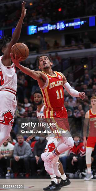 Trae Young of the Atlanta Hawks shoots against Ayo Dosunmu of the Chicago Bulls at the United Center on February 24, 2022 in Chicago, Illinois. NOTE...