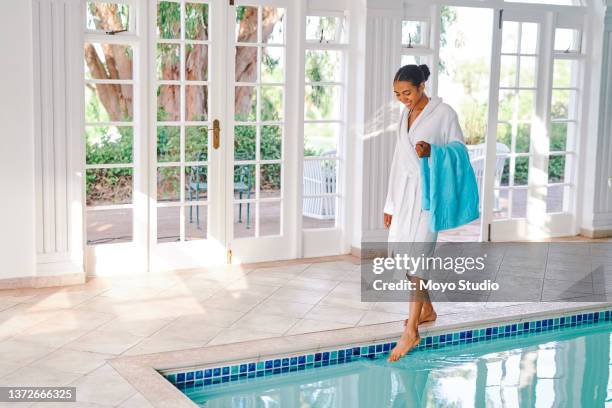 shot of a young woman going for a swim at a beauty spa - african american teen stockfoto's en -beelden
