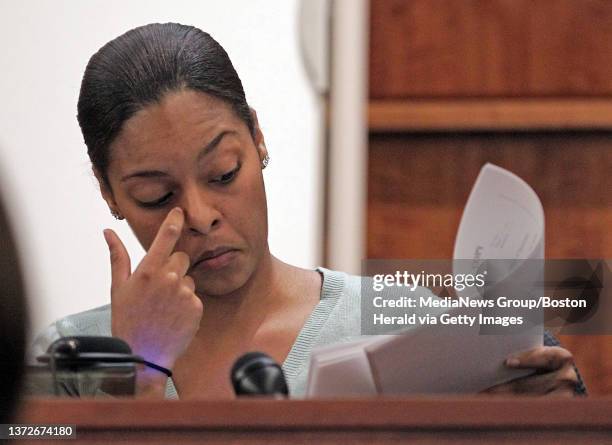 Shaneah Jenkins, the sister of Aaron Hernandez's fiancÈe Shayanna, looks at evidence on Tuesday during the trial for the killing of her boyfriend...