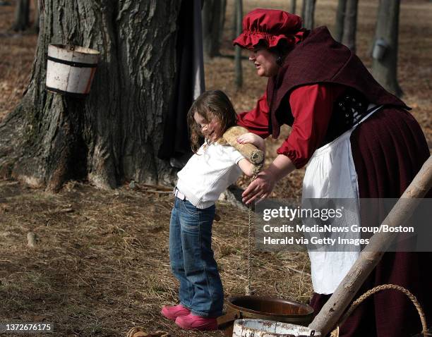 Sunday, Maple Sugaring Days at Brookwood Farms in the Blue HIlls. Volunteer Wendy Rapson demonstrates early settlers methods of making maple sugar...