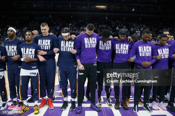 Players from the Denver Nuggets and the Sacramento Kings stand for a moment of silence for the people of Ukraine before their game at Golden 1 Center...