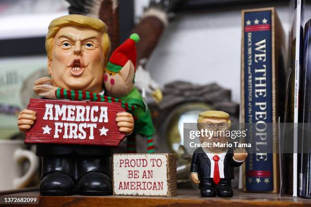 Figurines depicting former President Donald Trump are displayed at Great American Pizza and Subs, where participants in a convoy of truckers and...