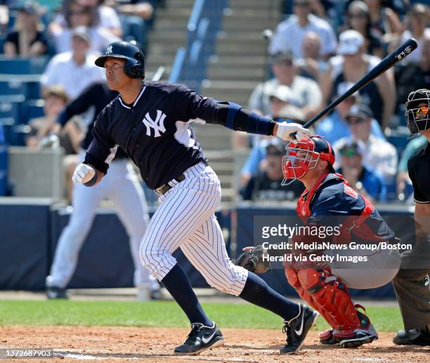 New York Yankees' Alex Rodriguez hits a solo home run off Boston Red Sox pitcher Brandon Workman, not in photo, as Boston Red Sox catcher Christian...