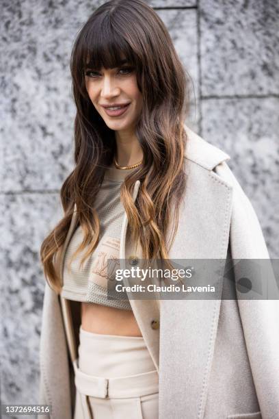 Melissa Satta poses ahead of the Max Mara fashion show wearing creme crop top, pants and coat during the Milan Fashion Week Fall/Winter 2022/2023 on...