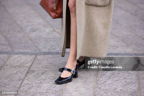 Eleonora Carisi poses ahead of the Max Mara fashion show wearing a creme Calcaterra coat during the Milan Fashion Week Fall/Winter 2022/2023 on...