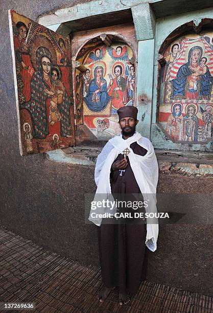 An Ethiopian Orthodox Christian monk poses while holding a cross at Ure Kidane Mihret monastery at Lake Tana in Bahar Dar, Ethiopia, on January 17,...