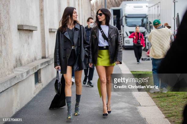 Giorgia Tordini wearing black skirt, leather blazer, grey socks, heels & Gilda Ambrosio seen wearing green skirt, leather jacket, belted bag, heels...