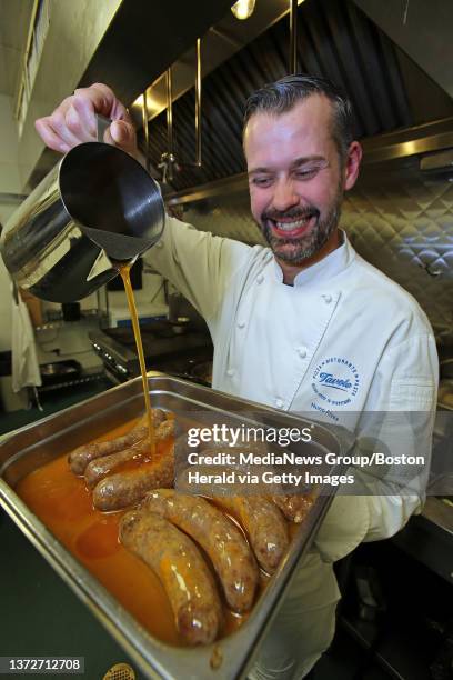 Nuno Alves, the chef at Tavolo pours fat onto his 'Nuno's spicy sausage', which they are cooked in, at his restaurant. Tuesday, March 18, 2014.