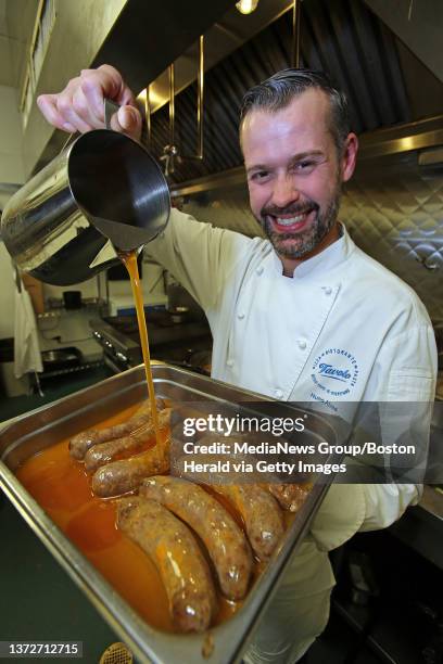 Nuno Alves, the chef at Tavolo pours fat onto his 'Nuno's spicy sausage', which they are cooked in, at his restaurant. Tuesday, March 18, 2014.